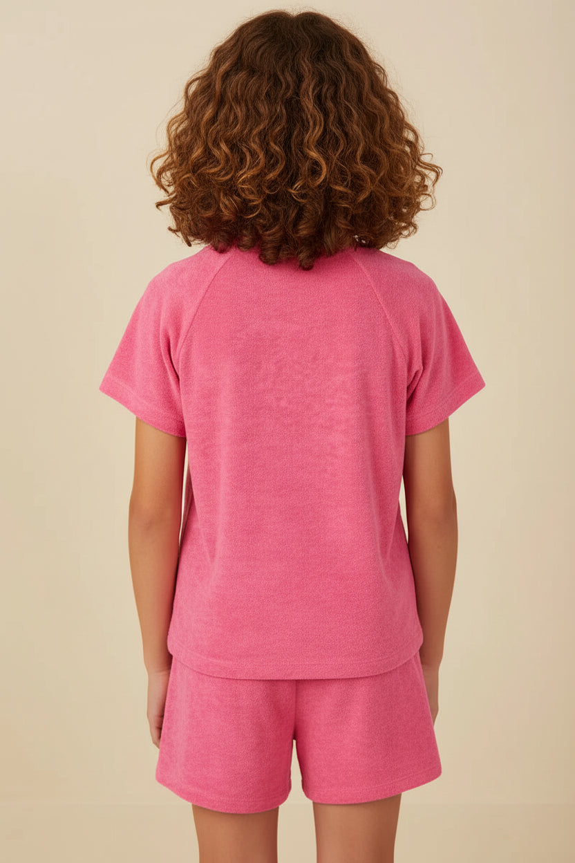 Child wearing a pink outfit on a beige background