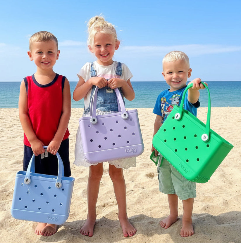 Three children holding colorful bags against a wooden panel background
