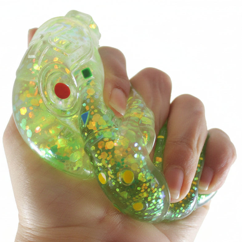 Hand holding a colorful, glittery object with 'Curious Minds' branding.