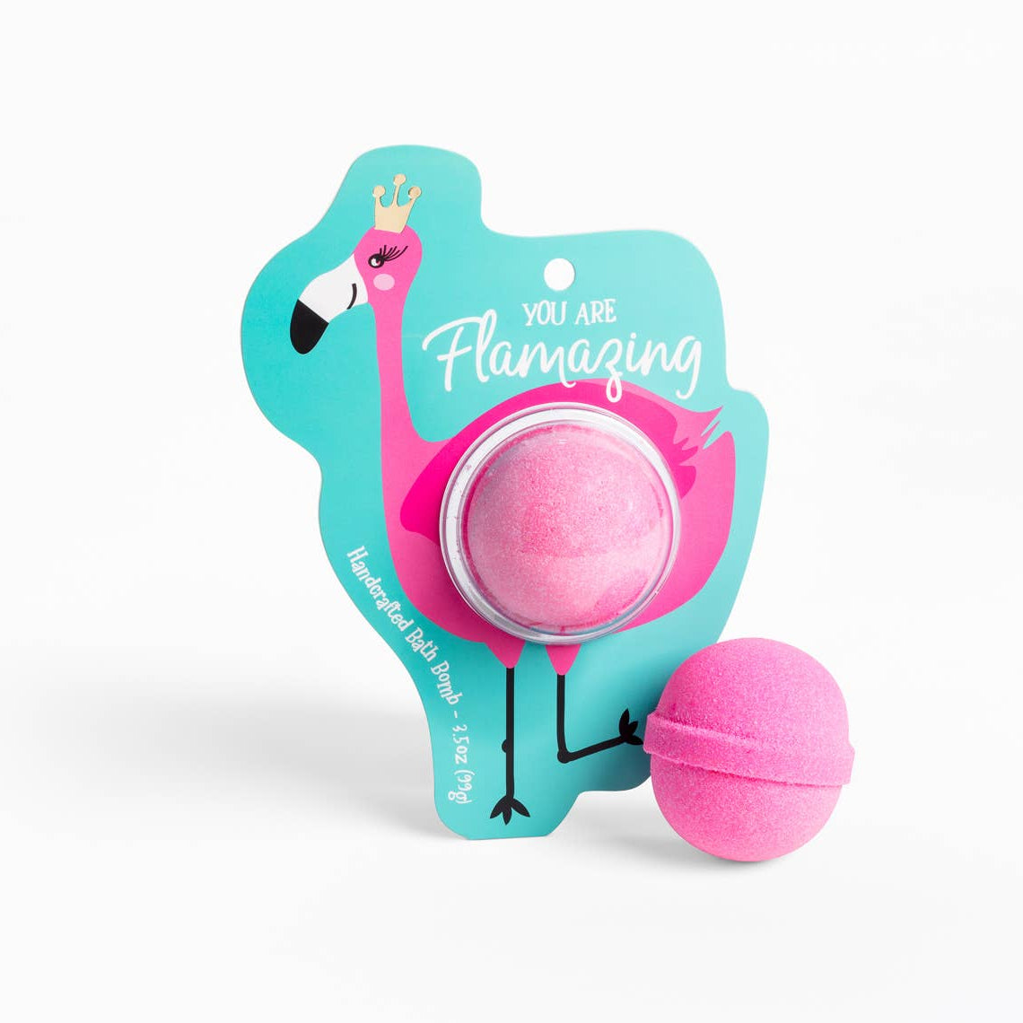 A pink bath bomb designed to resemble a flamingo, placed on a blue cardboards packaging with the text 'Flamazing'.