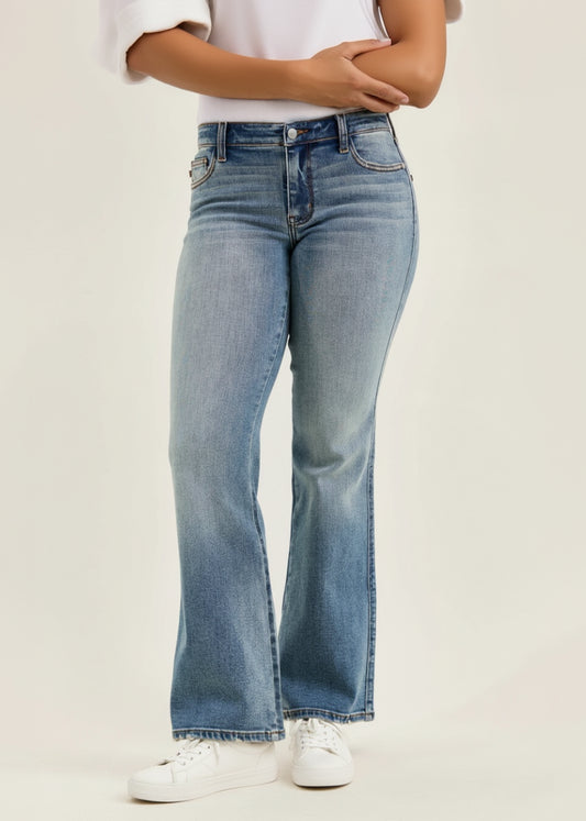 Light blue flared jeans worn by a person on a plain background