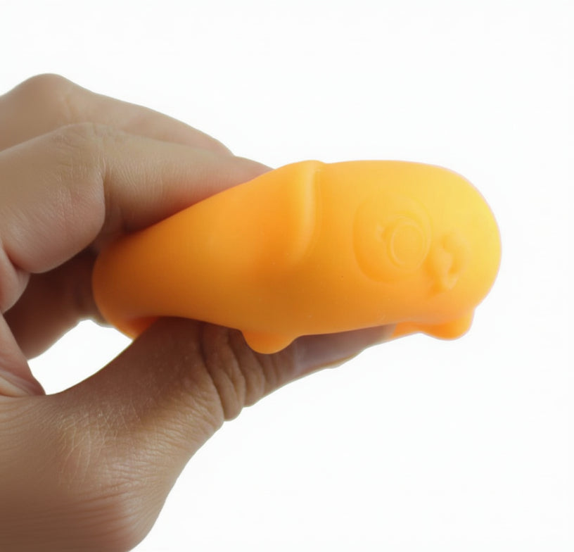 Orange squishy toy held in a hand with 'Curious Minds' branding.