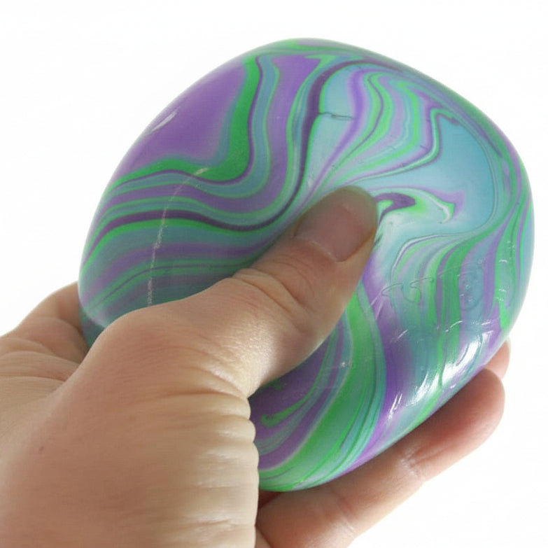 Hand holding a marbled stress ball with 'Curious Minds' branding.
