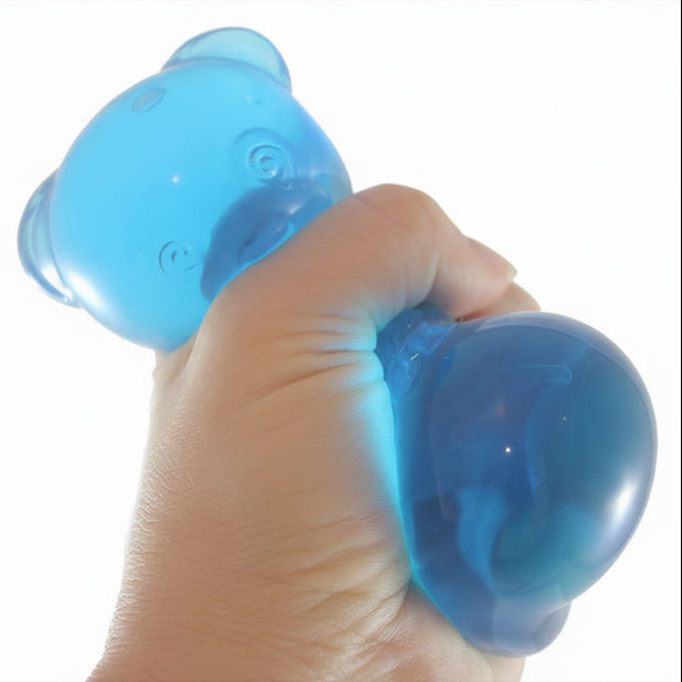 Hand holding a blue stress ball with 'Curious Minds Busy Bags' branding.