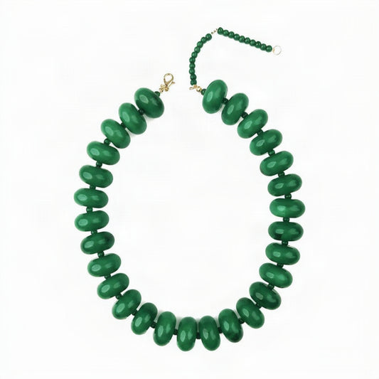Green beaded necklace on a white background