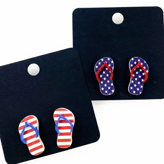 Flip-flop earrings with American flag design on black 'Doohickies' cards.