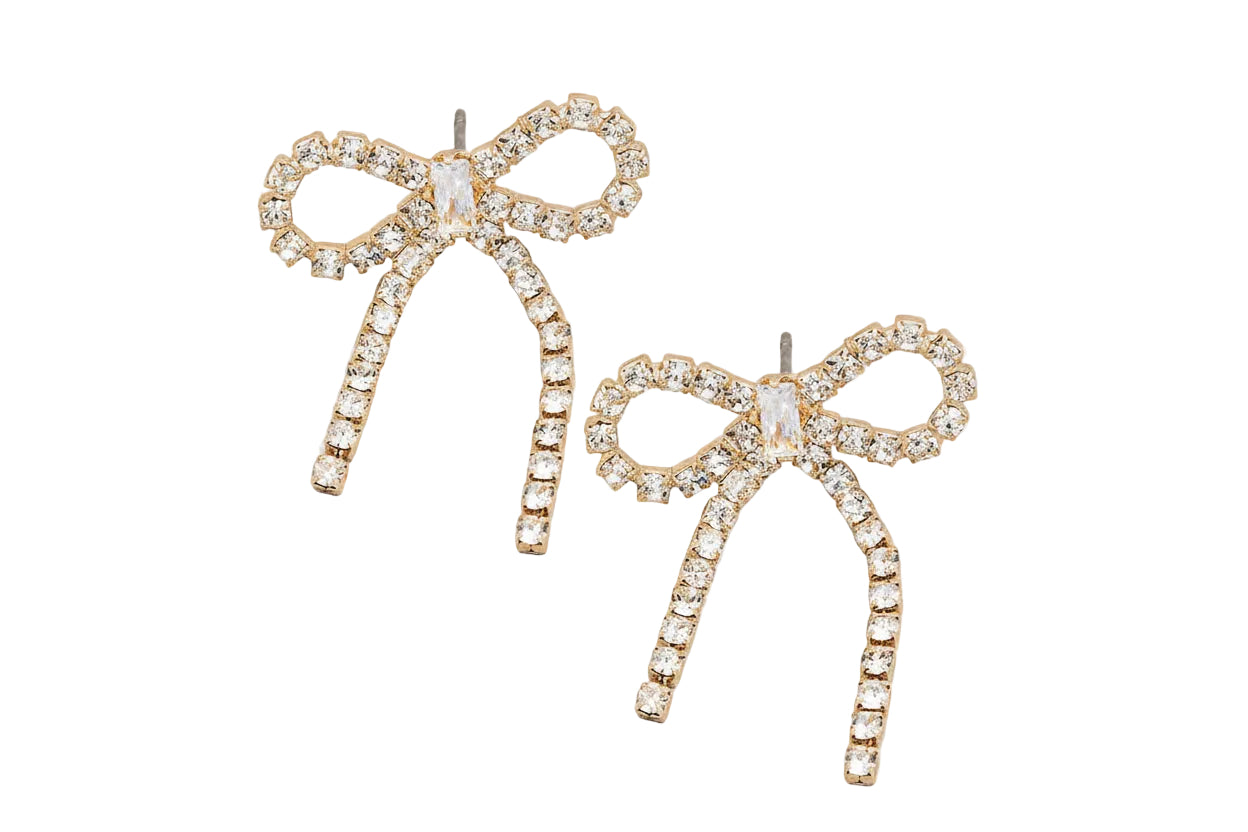 Bow-shaped earrings with rhinestones on a gray background