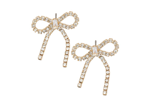 Bow-shaped earrings with rhinestones on a gray background