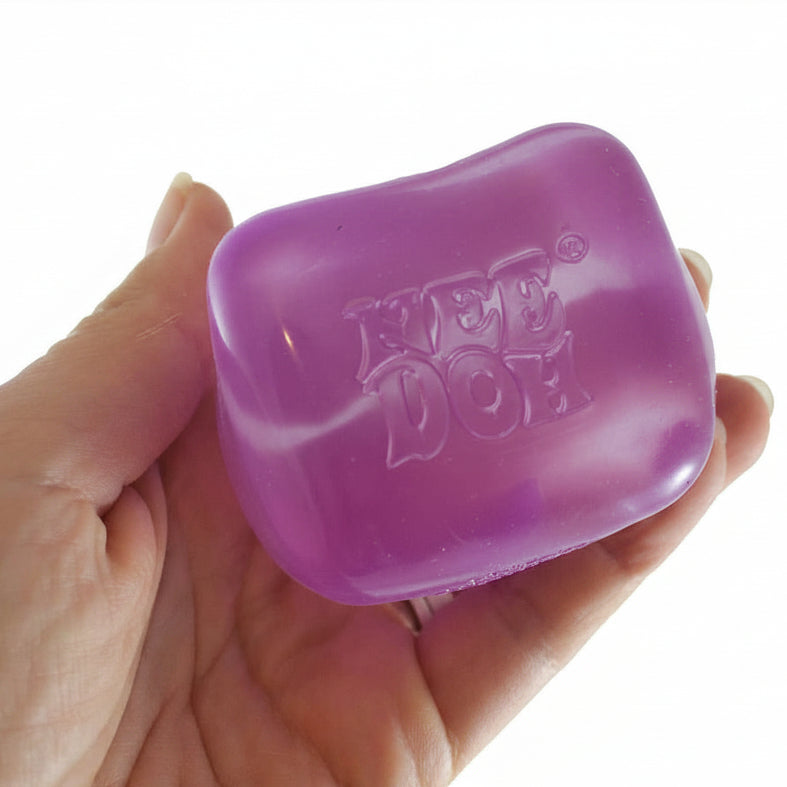 Purple toy with 'Pet Dog' branding held in a hand, branded 'Curious Minds Busy Bags'.