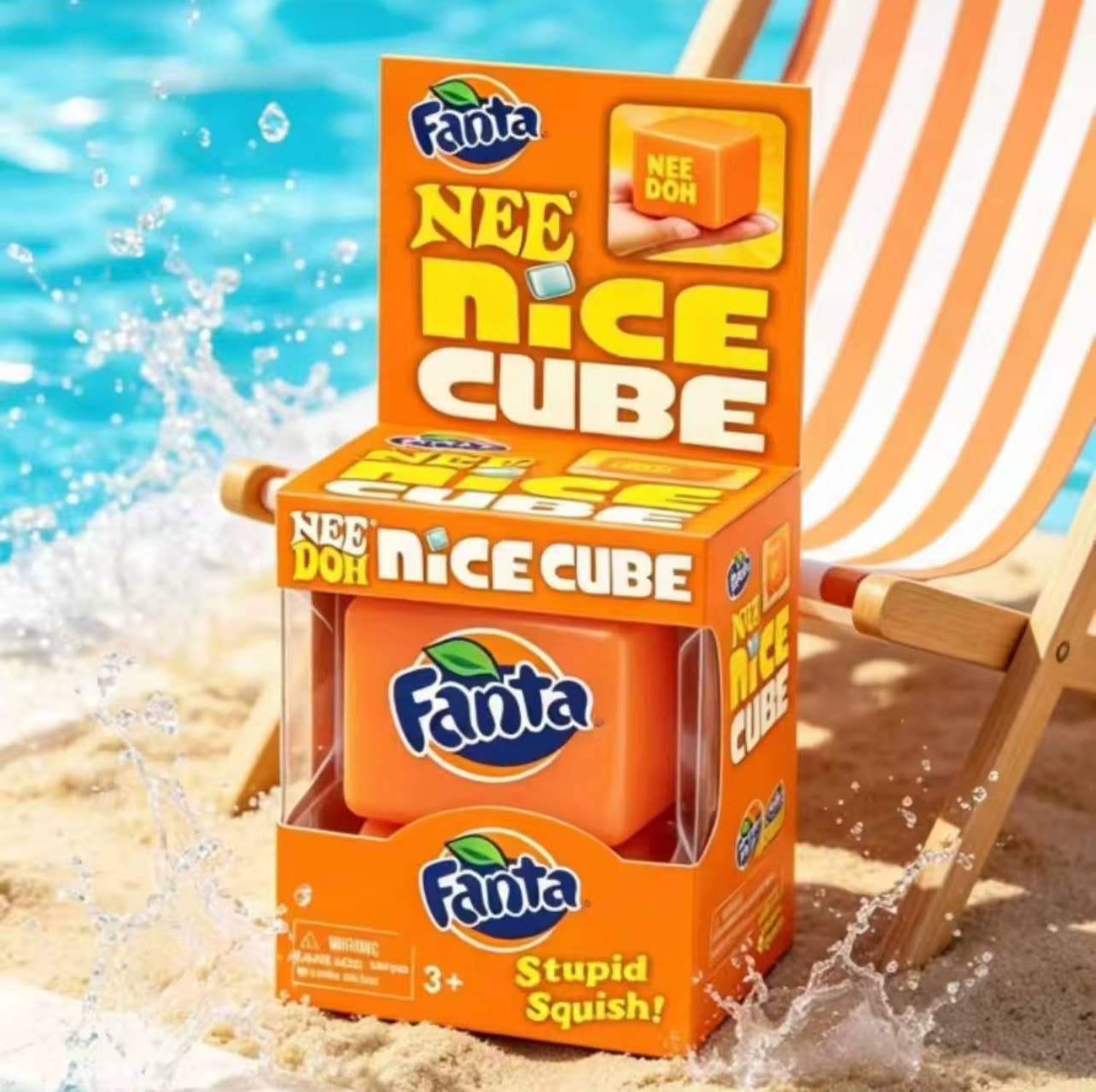 Fanta Nee Nice Cube packaging on a beach with water and a chair in the background