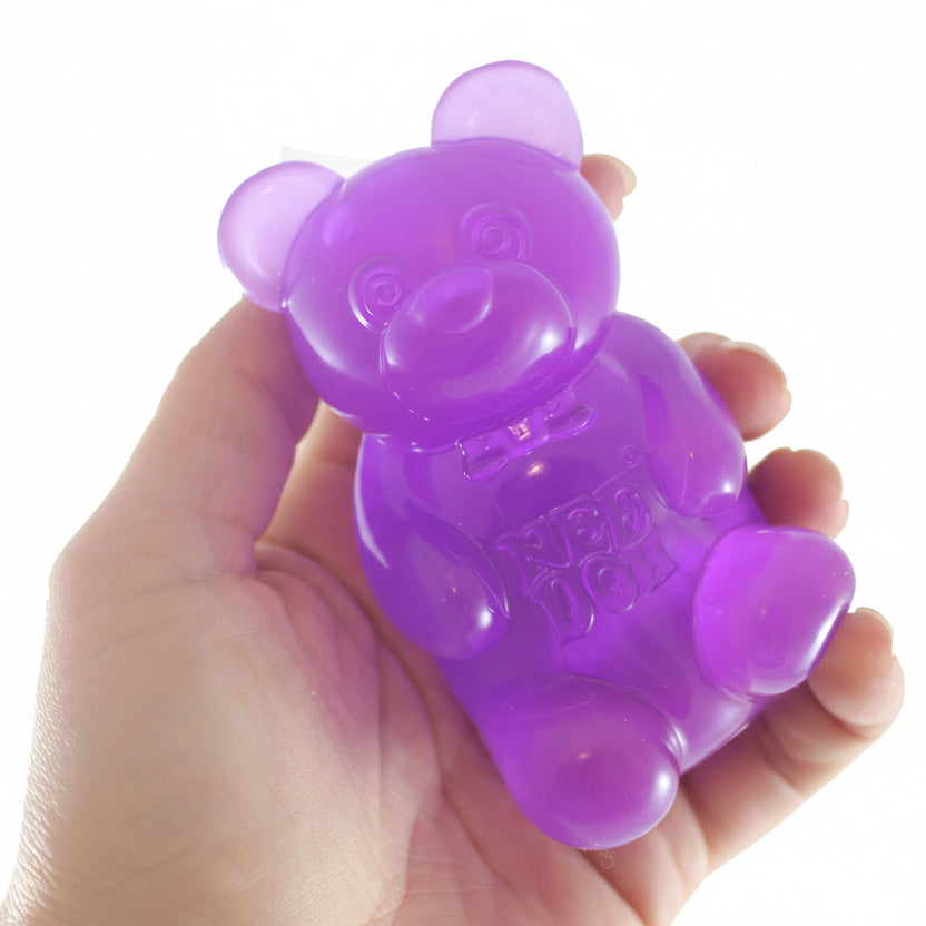 Purple bear-shaped toy held in a hand with 'Curious Minds' branding.