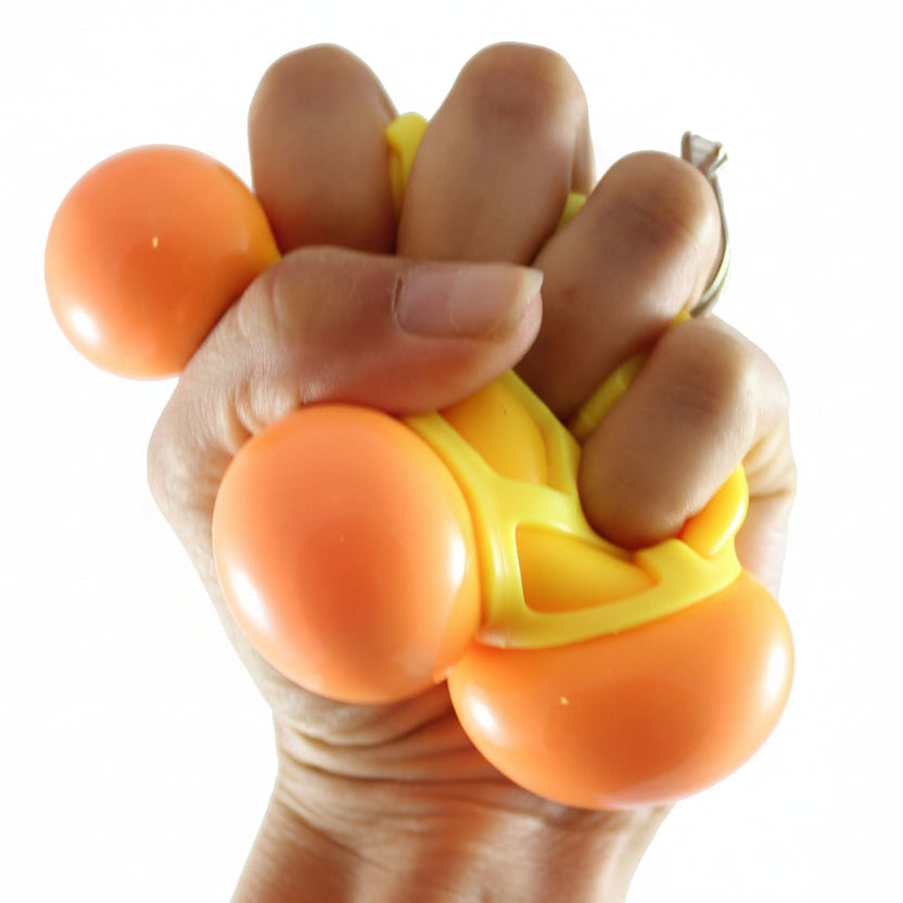 Hand using an orange and yellow stress ball with 'Curious Minds' branding.