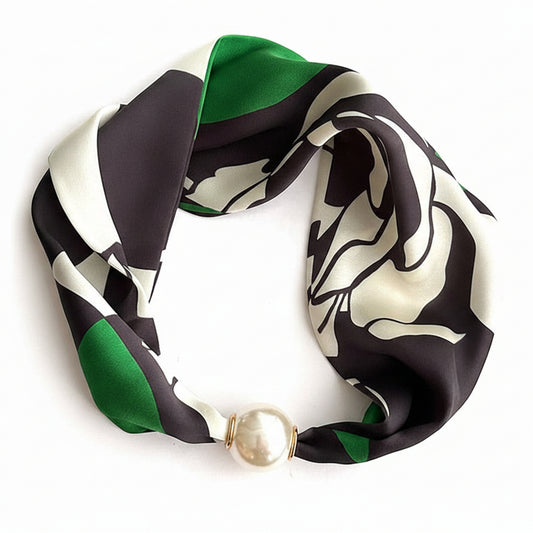 Patterned scarf with a pearl-like accessory on a LOEWE branded background