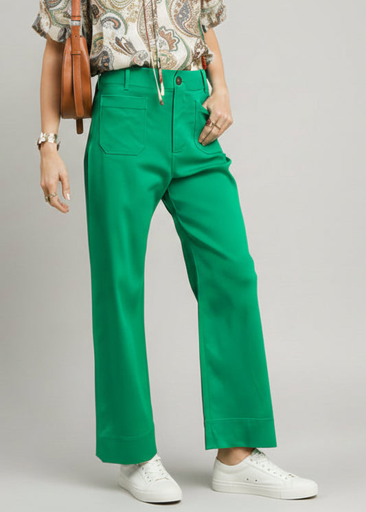 Green pants worn by a person on a light green background