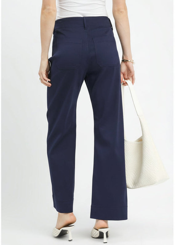 Navy pants worn by a person on a white background