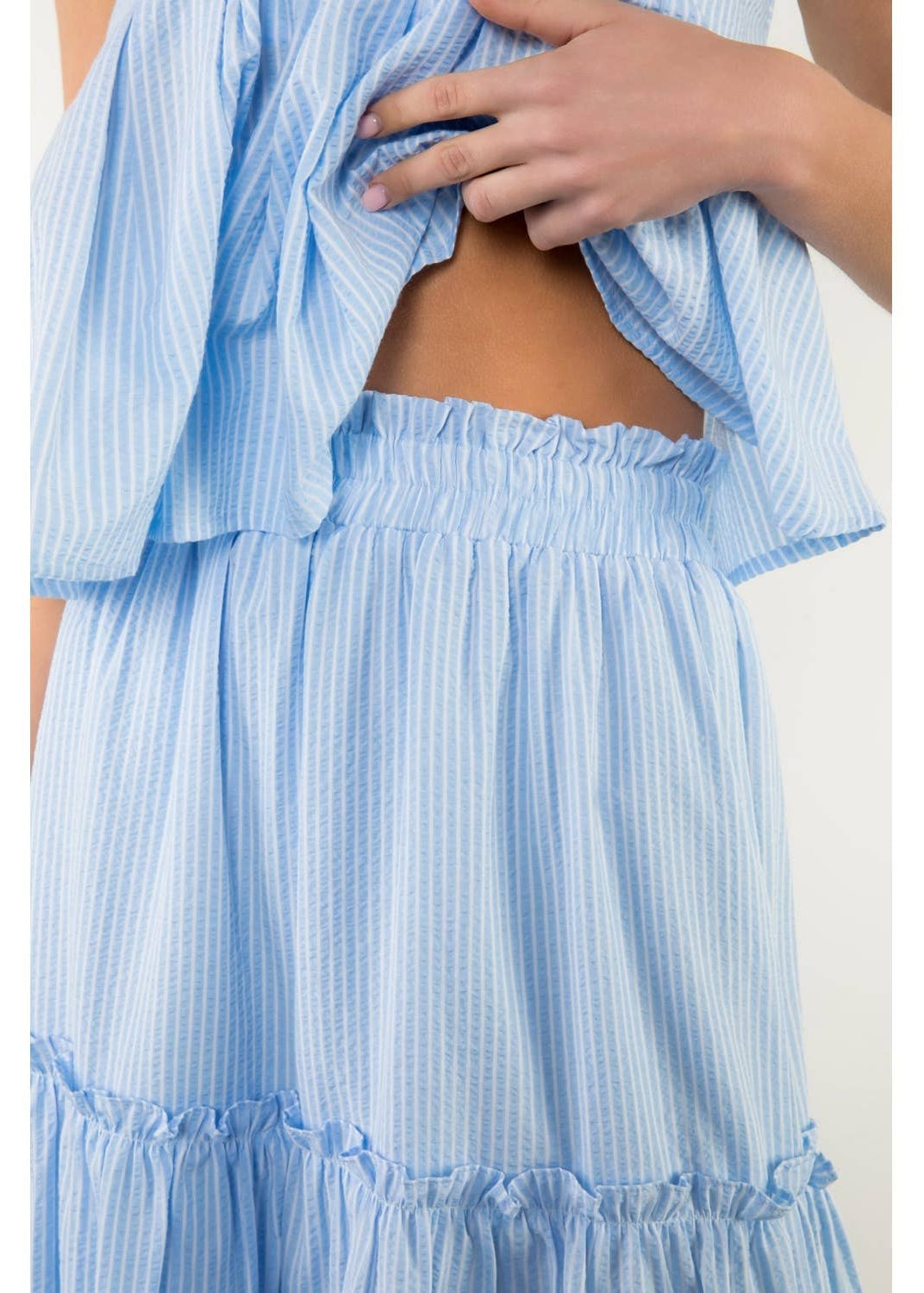 Light blue striped dress with a cut-out design on a white background