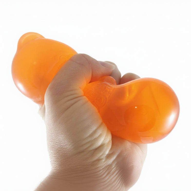 Hand holding an orange stress ball with 'Curious Minds' branding.