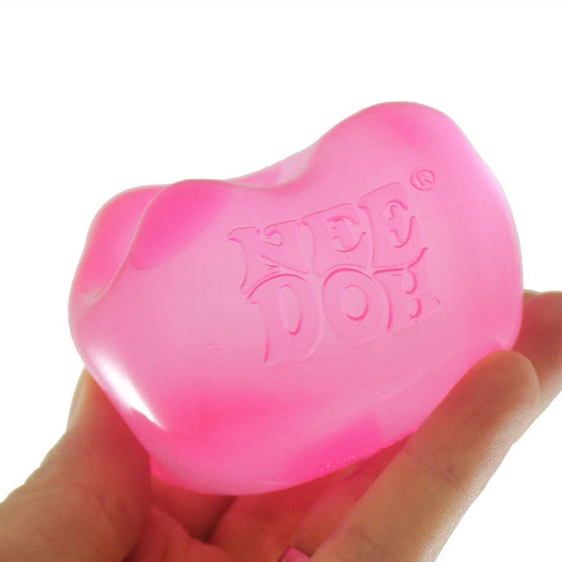 Pink dog toy held in a hand with 'Curious Minds' branding.