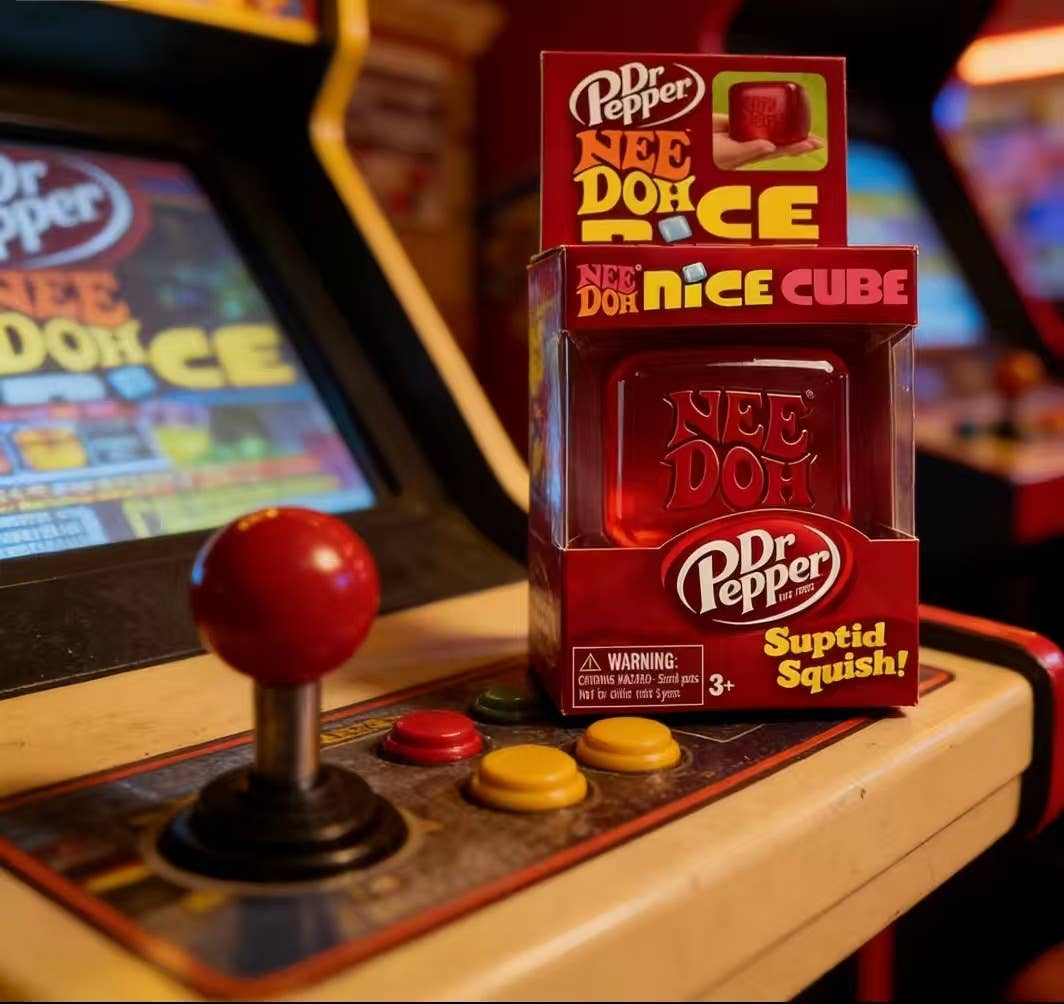 Dr Pepper Nee Doh Rice and Nee Doh Nice Cube packaging in front of an arcade machine.