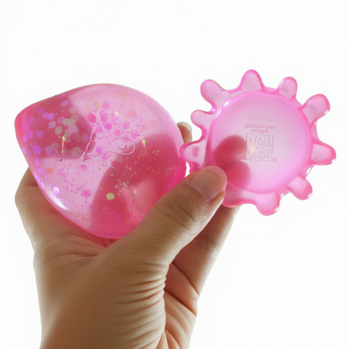 Pink textured stress balls held in a hand with 'Curious Minds' branding.