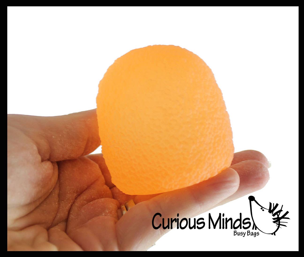 Orange stress ball held in a hand with 'Curious Minds Busy Bags' branding.