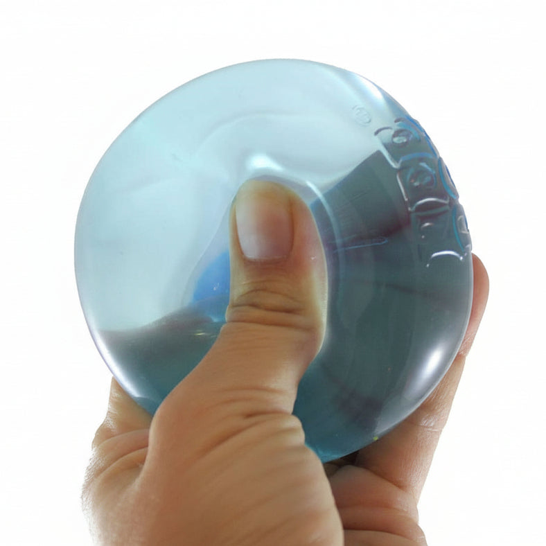 Hand holding a blue stress ball with 'Curious Minds Busy Bags' branding.