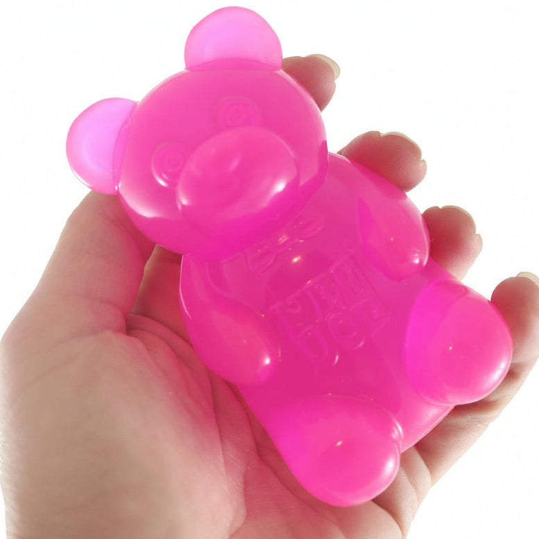 Pink bear-shaped toy held in a hand with 'Curious Minds Busy Bags' branding.