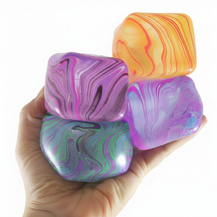 Colorful marbled stones held in a hand with 'Curious Minds' branding.