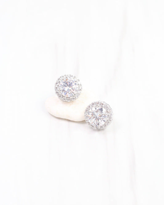 Pair of silver stud earrings with clear gemstones on a white background