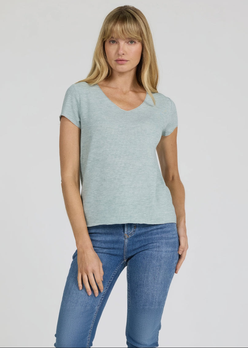 Woman wearing a light blue t-shirt and jeans