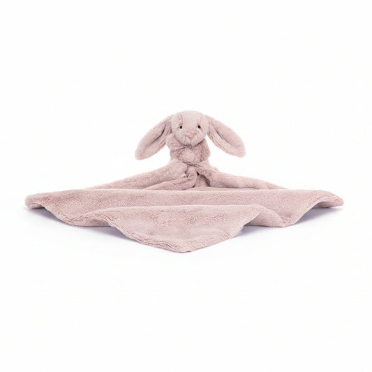 Pink bunny plush toy with blanket on a white background