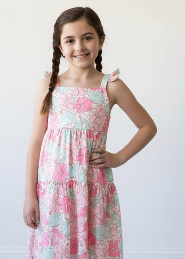 Girl wearing a pink floral dress on a white background
