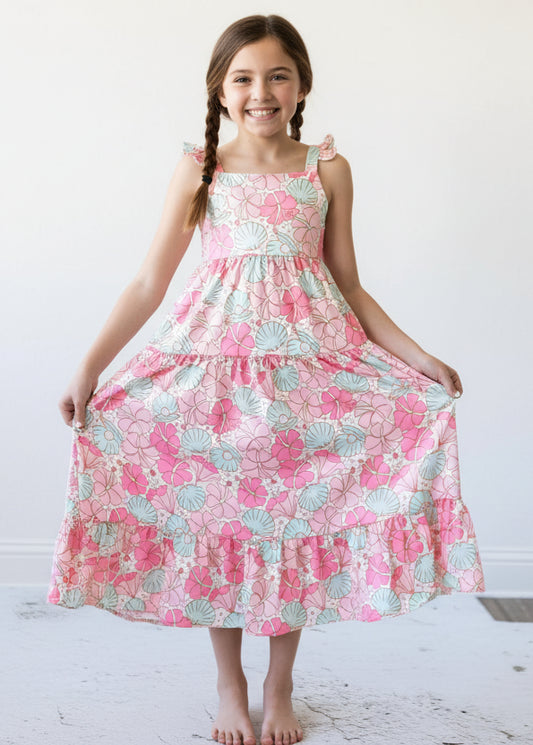 Girl wearing a pink floral dress on a white background