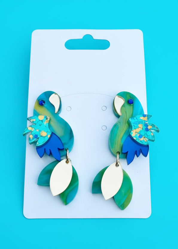 Pair of teal and blue earrings on a white card with 'STR' branding against a blue background.