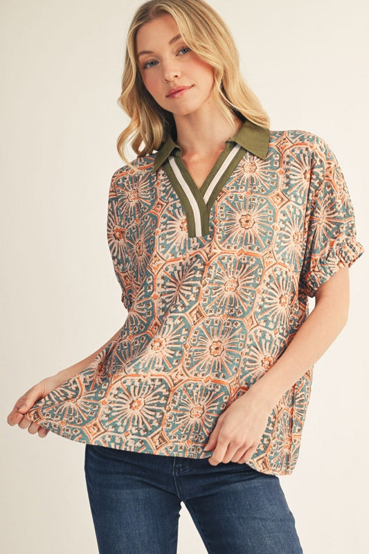 Woman wearing a patterned blouse with a neutral background