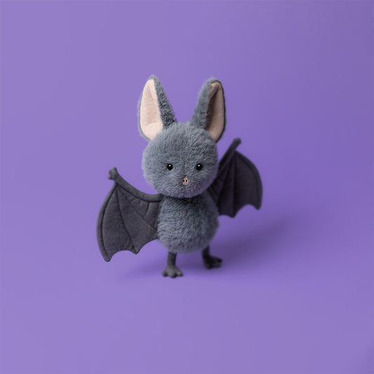 Plush toy bat on a purple background