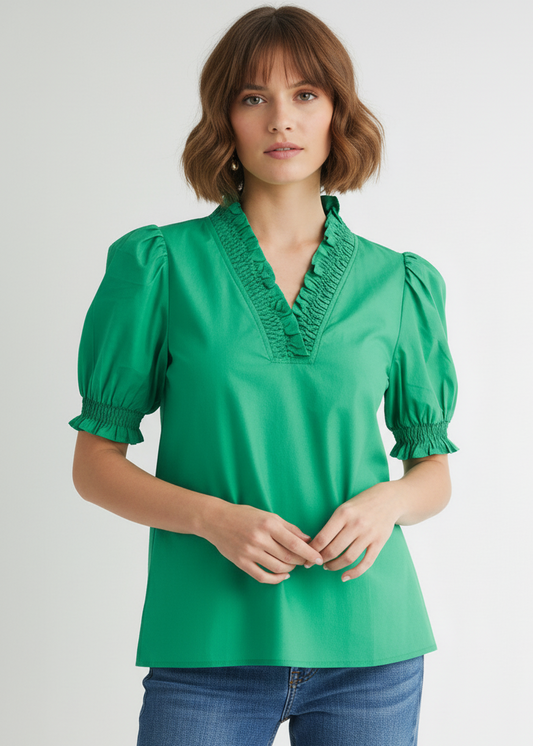 Woman wearing a green blouse with puffed sleeves on a white background