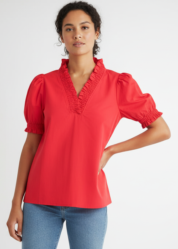 Woman wearing a red blouse with puffed sleeves on a white background