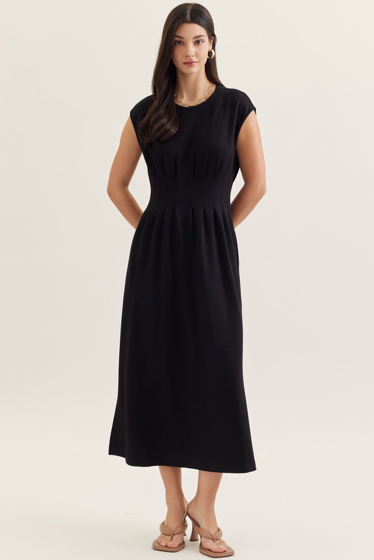 Woman wearing a black dress on a white background