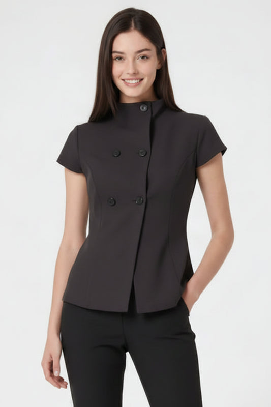 A woman modeling a black short-sleeve double-breasted blazer with a high mock neck, paired with black trousers, against a plain white studio background.