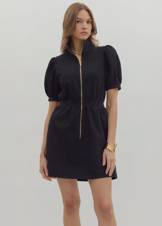 Woman wearing a black dress with puff sleeves on a white background