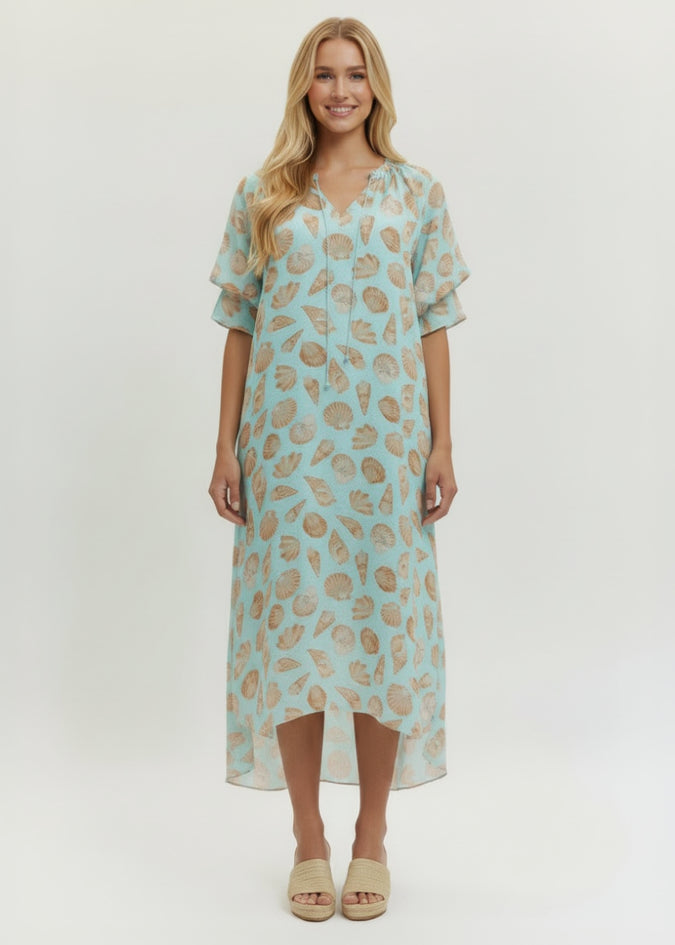 Woman wearing a light blue dress with floral pattern on a white background