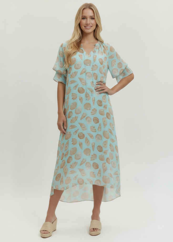 Woman wearing a light blue dress with floral pattern on a white background