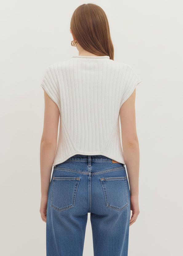 Person wearing a white sleeveless top and shorts on a plain background
