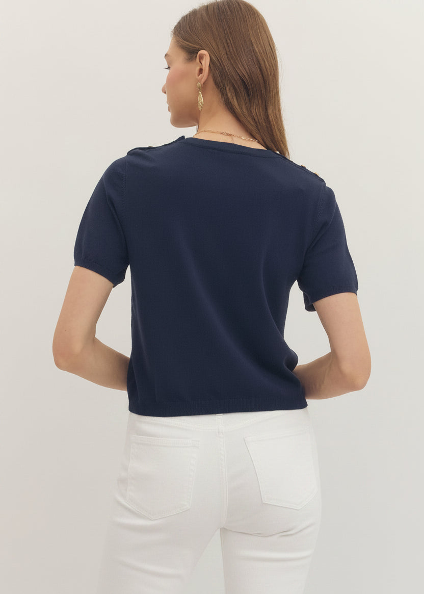 Person wearing a navy blue t-shirt and pants on a light gray background