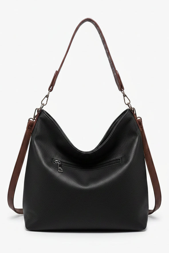 Brown leather handbag with a shoulder strap on a white background