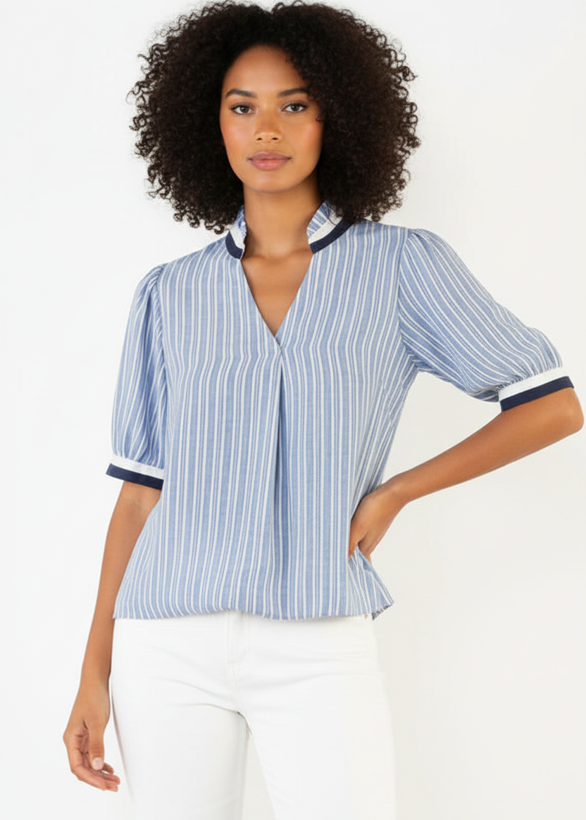 Woman wearing a blue and white striped shirt with a plain background