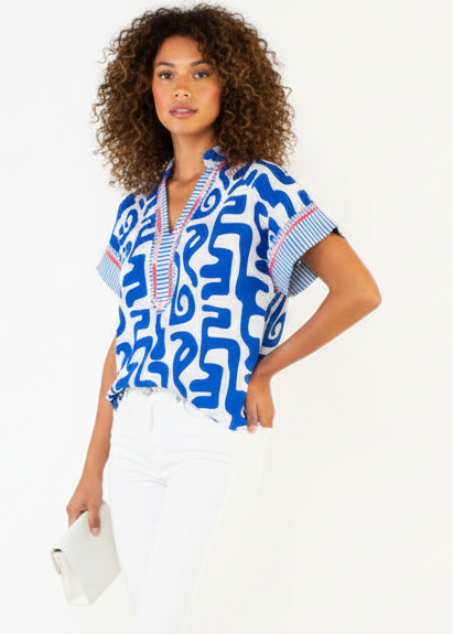 Woman wearing a blue and white patterned blouse on a white background
