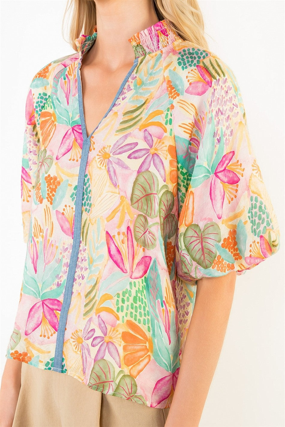 Woman wearing a colorful floral jacket on a white background