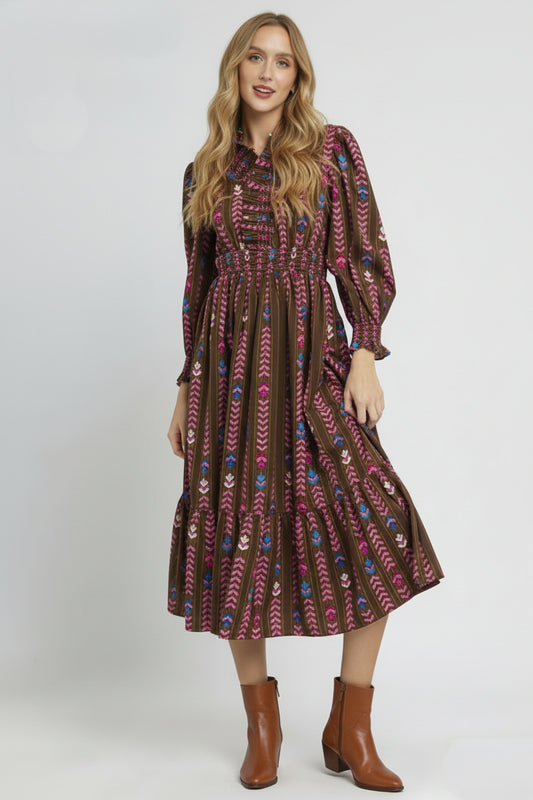 Woman wearing a patterned dress on a white background